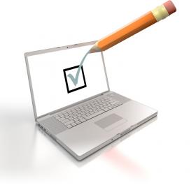 open laptop with screen showing green tick and orange pencil ticking screen